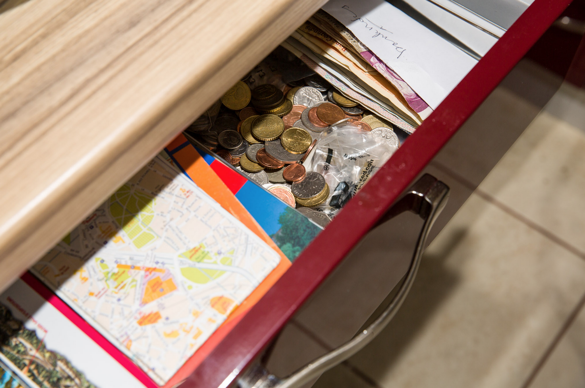 Leftover coins and notes in a drawer