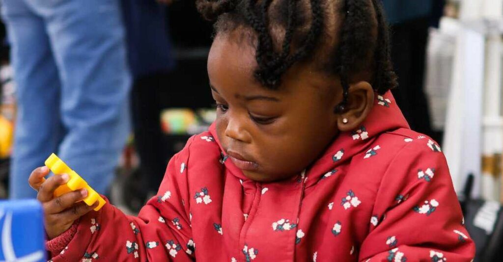 Image of a little girl playing with toys at Little Village