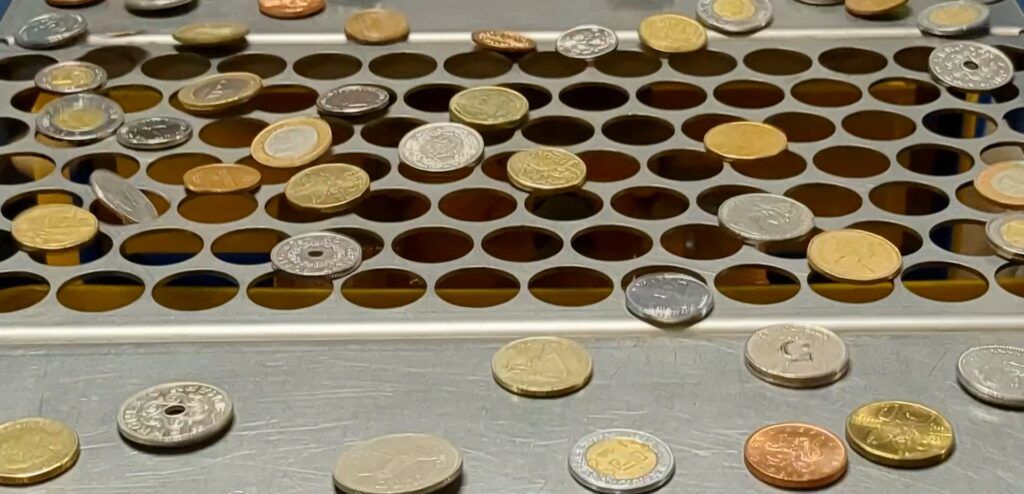 Coins being sorted by a size sorting machine
