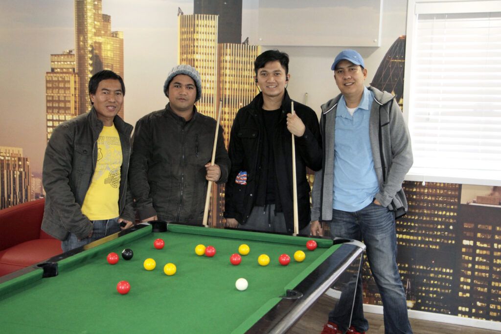 image of 4 people playing pool at QVSR.