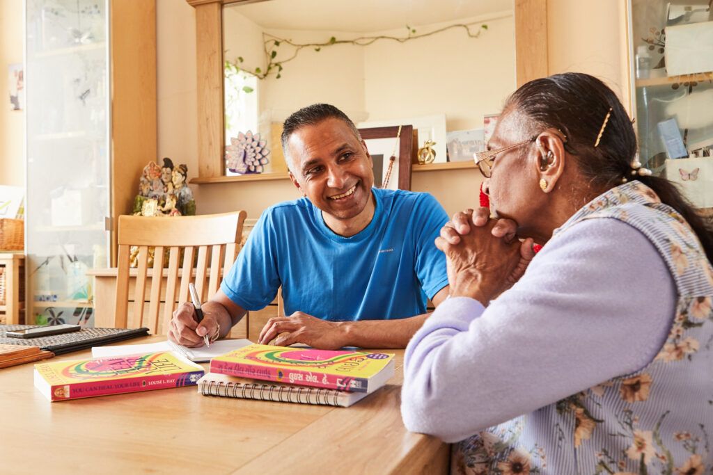 A carer looking after an elderly woman in her home.