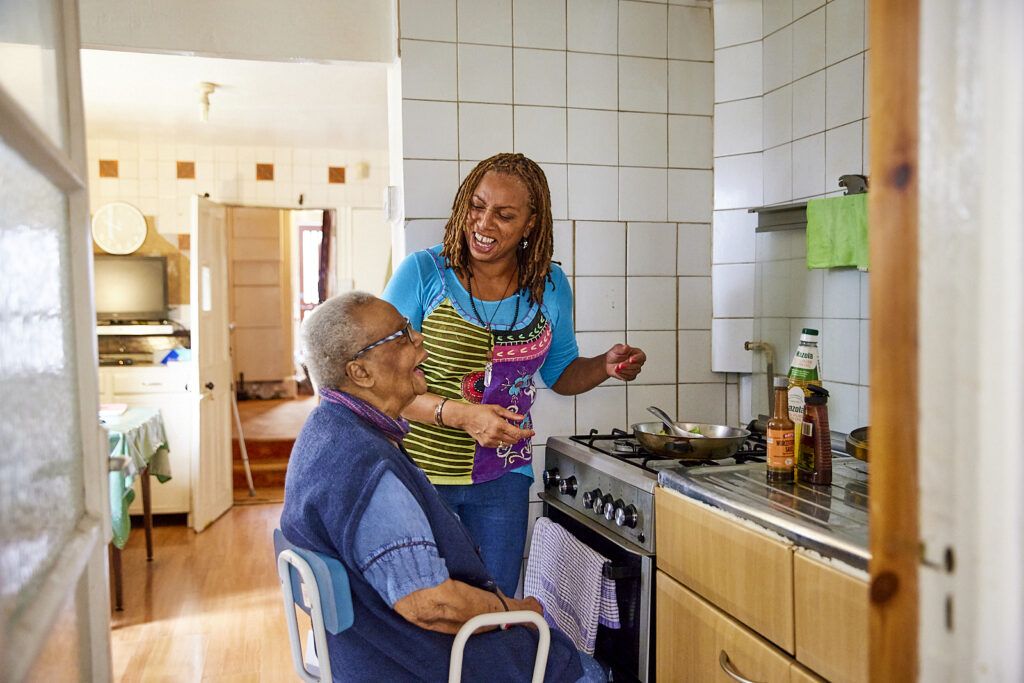 A carer looking after an elderly lady at her home