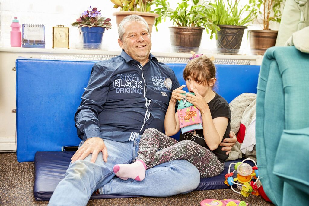 young child and her parent being looked after by Carers UK