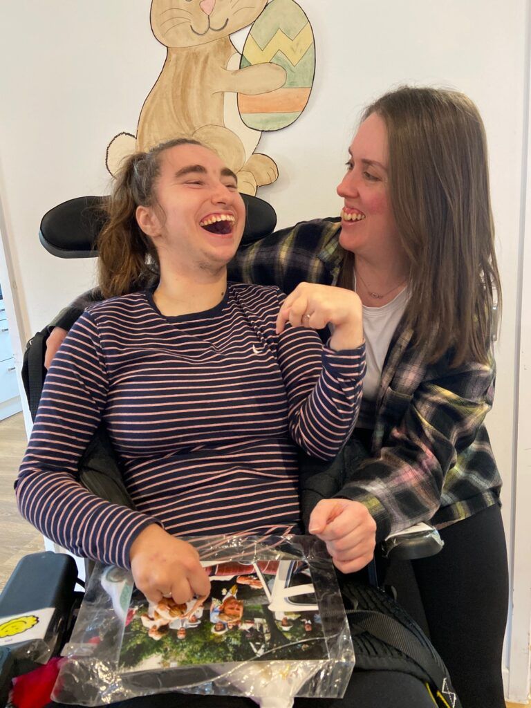 Image of volunteer with a teenager at Dame Hannahs