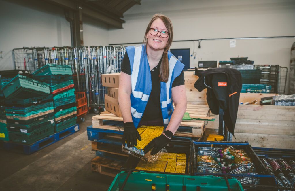 Member of FareShare Midlands unpacking food
