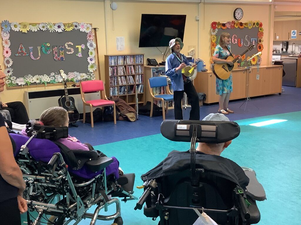 residents enjoying a musical performance at Marillac Neurological care centre