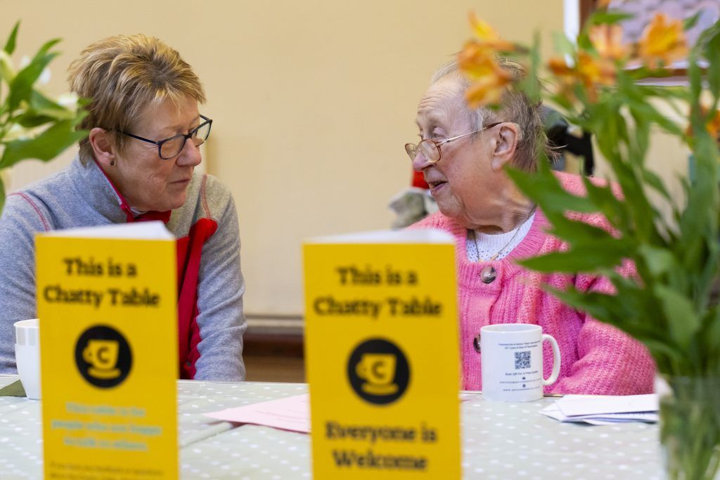 two elderly people having a conversation